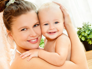 Mother and daughter play in the bedroom