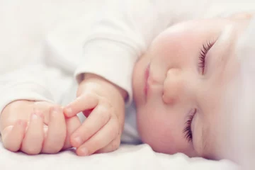 Foto op Plexiglas close-up portrait of a beautiful sleeping baby on white © Olesia Bilkei