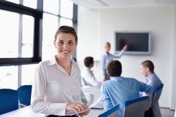 Fototapeta premium business woman with her staff in background at office