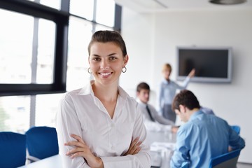Fototapeta premium business woman with her staff in background at office