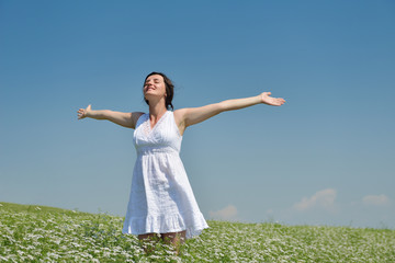 Young happy woman in green field