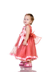 Baby in an elegant pink dress. isolated on white