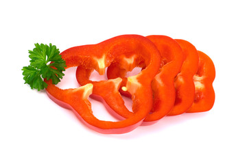 Cut red pepper isolated on white background, with parsley, close