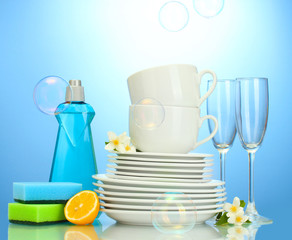 empty clean plates, glasses and cups with dishwashing liquid,