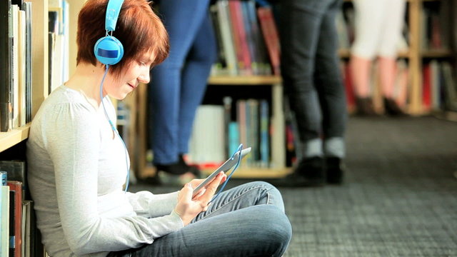 Caucasian female study online education in library