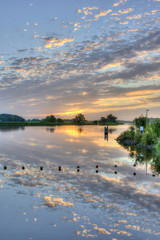 Naklejka premium Summer sunrise over a small lake