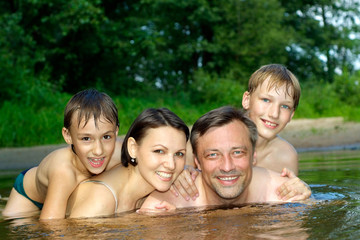 Happy family having fun on the river