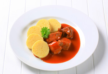 Pork in tomato sauce with potato dumplings