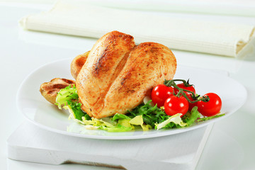 Roasted chicken breasts with potatoes and salad