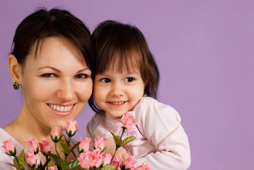 Smile Caucasian female with a daughter and flowers