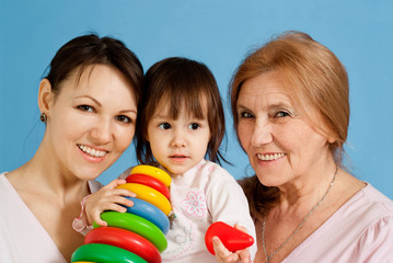 A beautiful Caucasian baby with her mother and grandmother