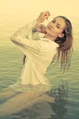 Fototapeta na wymiar Young pretty woman in the water