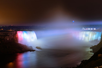 Niagara Falls illuminated colored lights at night time