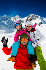 Skiing, winter fun - happy family ski team