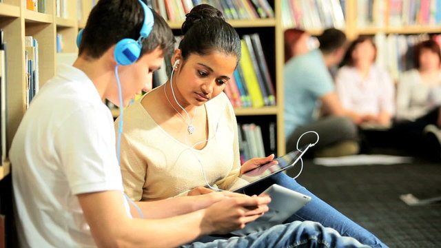 Young students study and listening to mp3 player 
