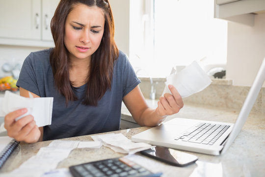 Young woman getting stressed over finances