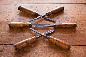 Old wooden chisels on the wood table