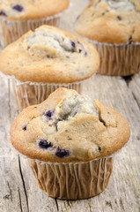 home made blueberry muffins on a timber board