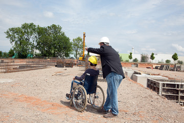 Architect shows disabled woman in wheelchair construction sites