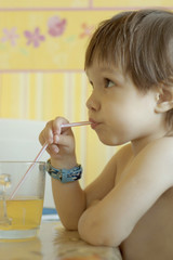 Nice little girl drinking juice