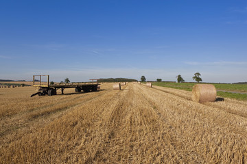 yellow trailer with straw bales