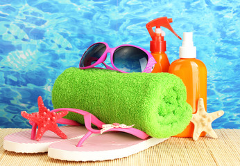 bright beach accessories, on blue sea background