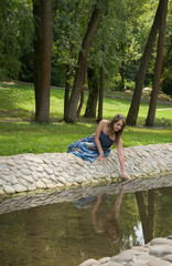 Beautiful woman near stream, reflection