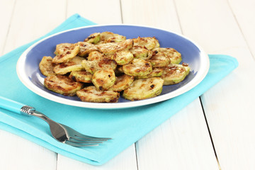 roasted squash in a blue bowl with fork
