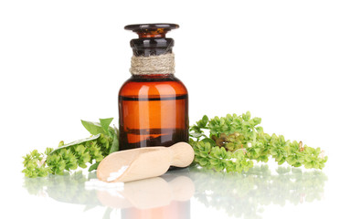 medicine bottle with tablets and flowers isolated on white
