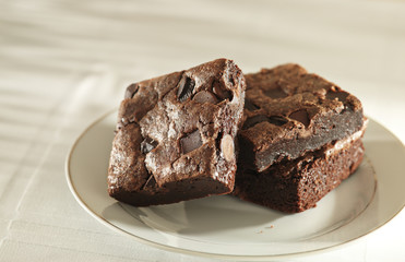 Stack of brownies on a plate.