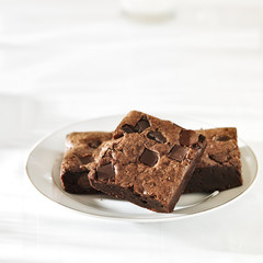 Stack of brownies on a plate with copy space composition
