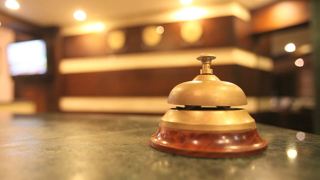 call on a old hotel bell on a wood stand