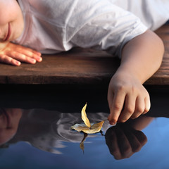 leaf ship in children hand, focus on hand