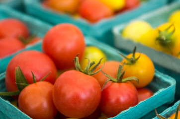 Small tomatoes in boxes at the market