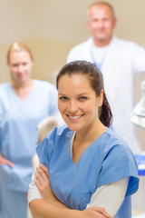 Fototapeta premium Smiling dental hygienist woman with team