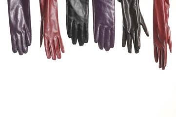 Row of colorful leather gloves isolated