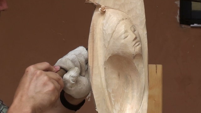Sculptor working on a wooden
