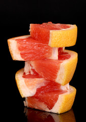 Sliced grapefruit isolated on black