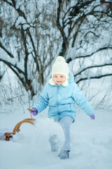 Fototapeta na wymiar Little girl on sledge