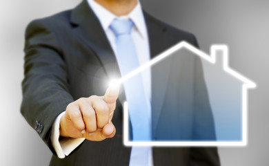 Businessman drawing his house with his finger