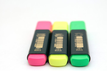Three colored markers on white background