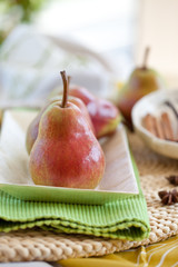 Red ripe pears in a mother-of-pearl bowl