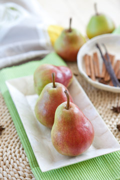 Red ripe pears in a mother-of-pearl bowl