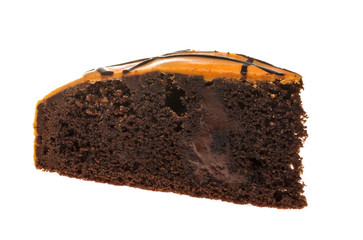Piece of chocolate cake with icing on white isolated background