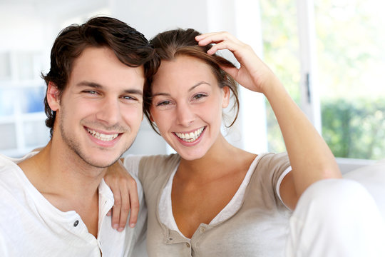 Portrait of smiling young couple at home