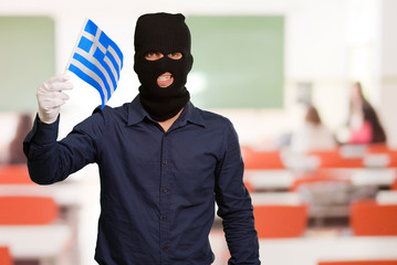 Portrait of a man wearing mask holding a flag