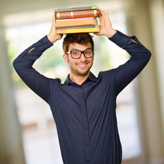 Young Man Holding Books