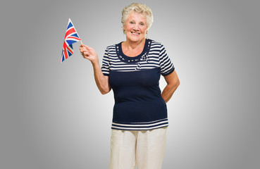 Senior Woman Waving United Kingdom Flag