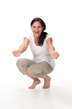 Attractive mom kneeling down and smiling with arms outstretched
