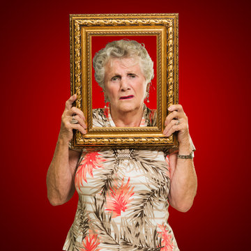 Unhappy Senior Woman Holding Picture Frame